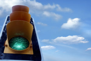 traffic lights while green light with clouds